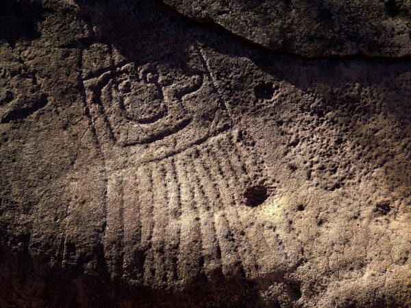 Petroglyph on rock in jungle
